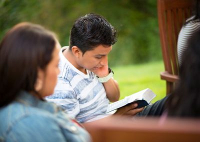 Boy and girl reading scriptures outside together